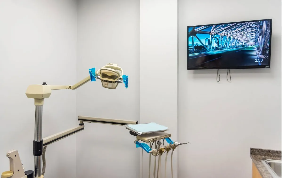Dental Korner treatment room with a wall-mounted TV